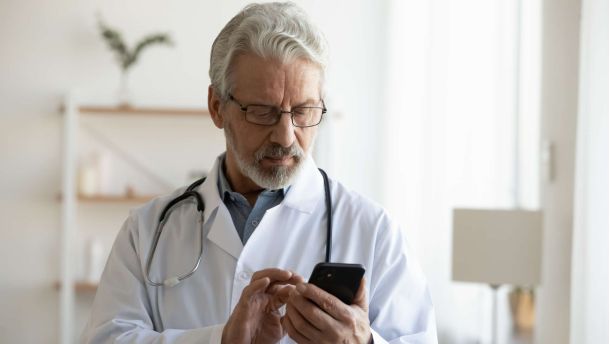 Doctor reading mobile phone